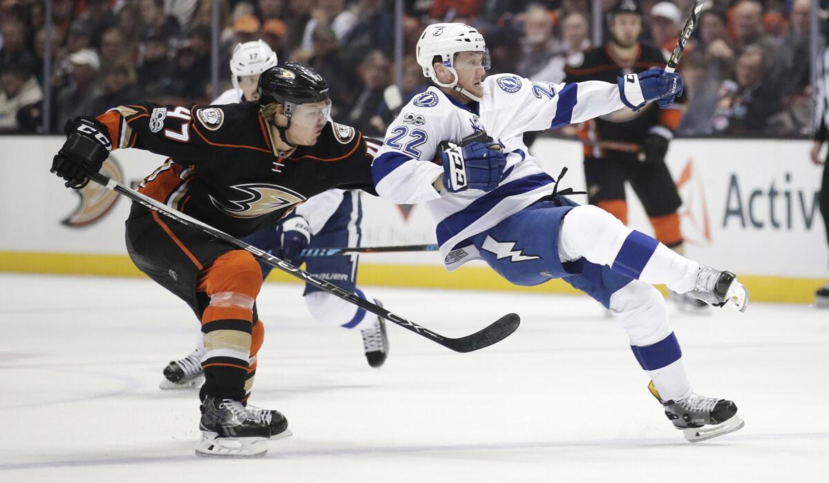 The Tampa Bay Lightning's Erik Condra, right, is the pulled by Ducks' Hampus Lindholm during a Jan. 17 game at Honda Center.