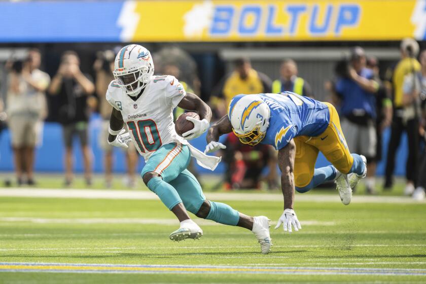 Miami Dolphins wide receiver Tyreek Hill (10) runs with the ball past Los Angeles Chargers safety Derwin James Jr. (3) during an NFL football game, Sunday, Sept. 10, 2023, in Inglewood, Calif. (AP Photo/Kyusung Gong)