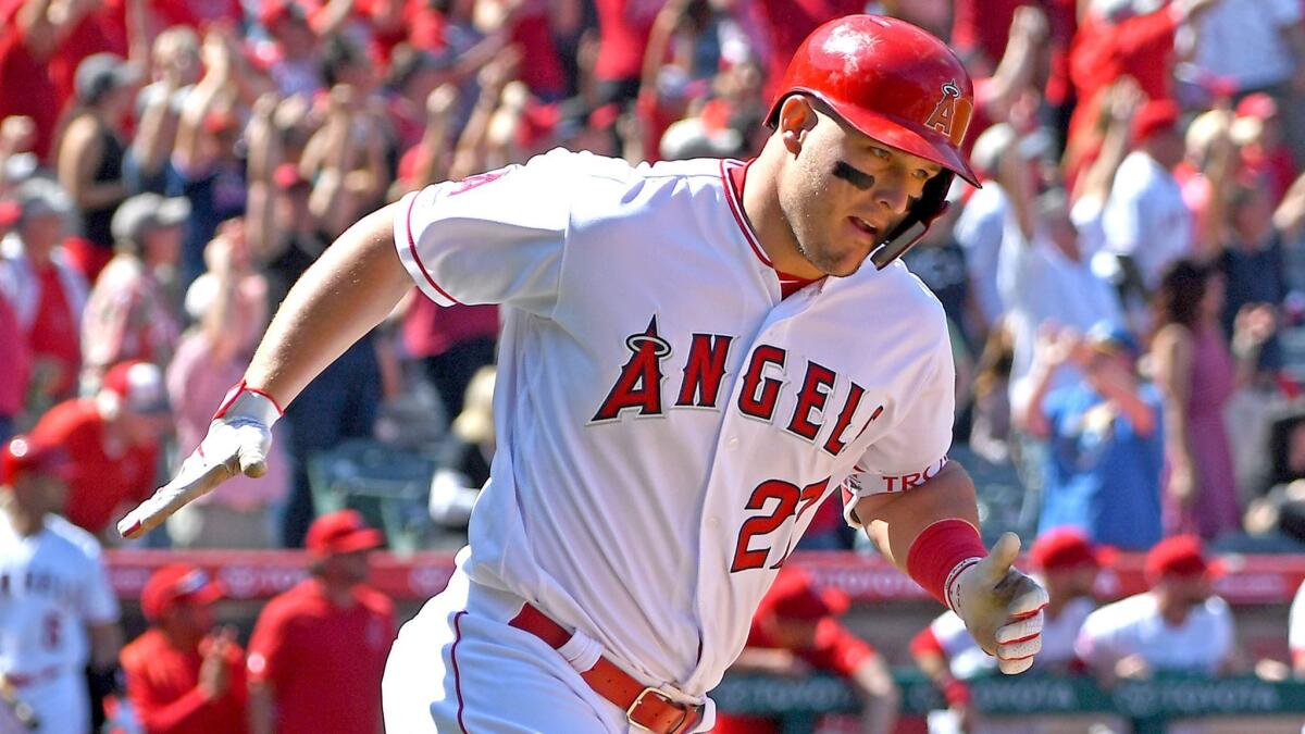 Angels' Mike Trout rounds the bases after hitting a grand slam against the Texas Rangers on April 6 in Anaheim.