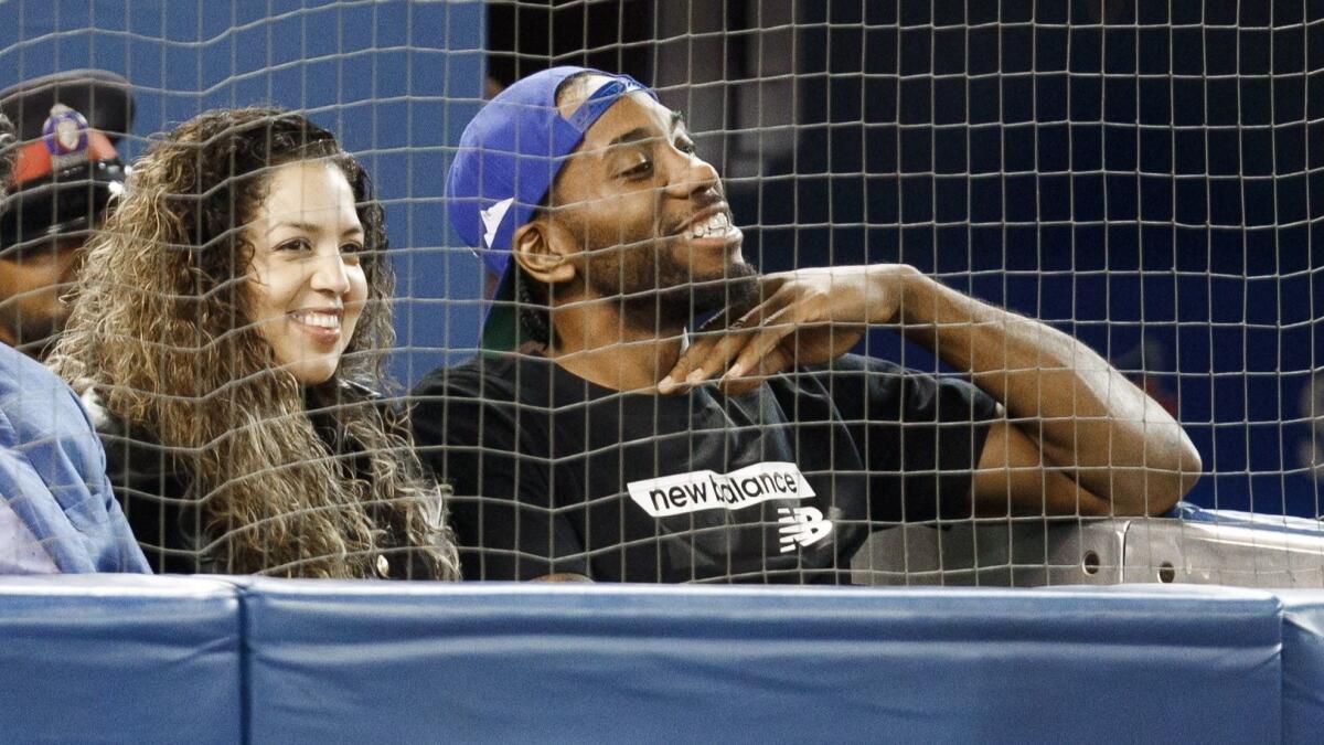 Kawhi Leonard and his girlfriend, Kishele Shipley, watch the Blue Jays play the Angels on June 20 in Toronto.
