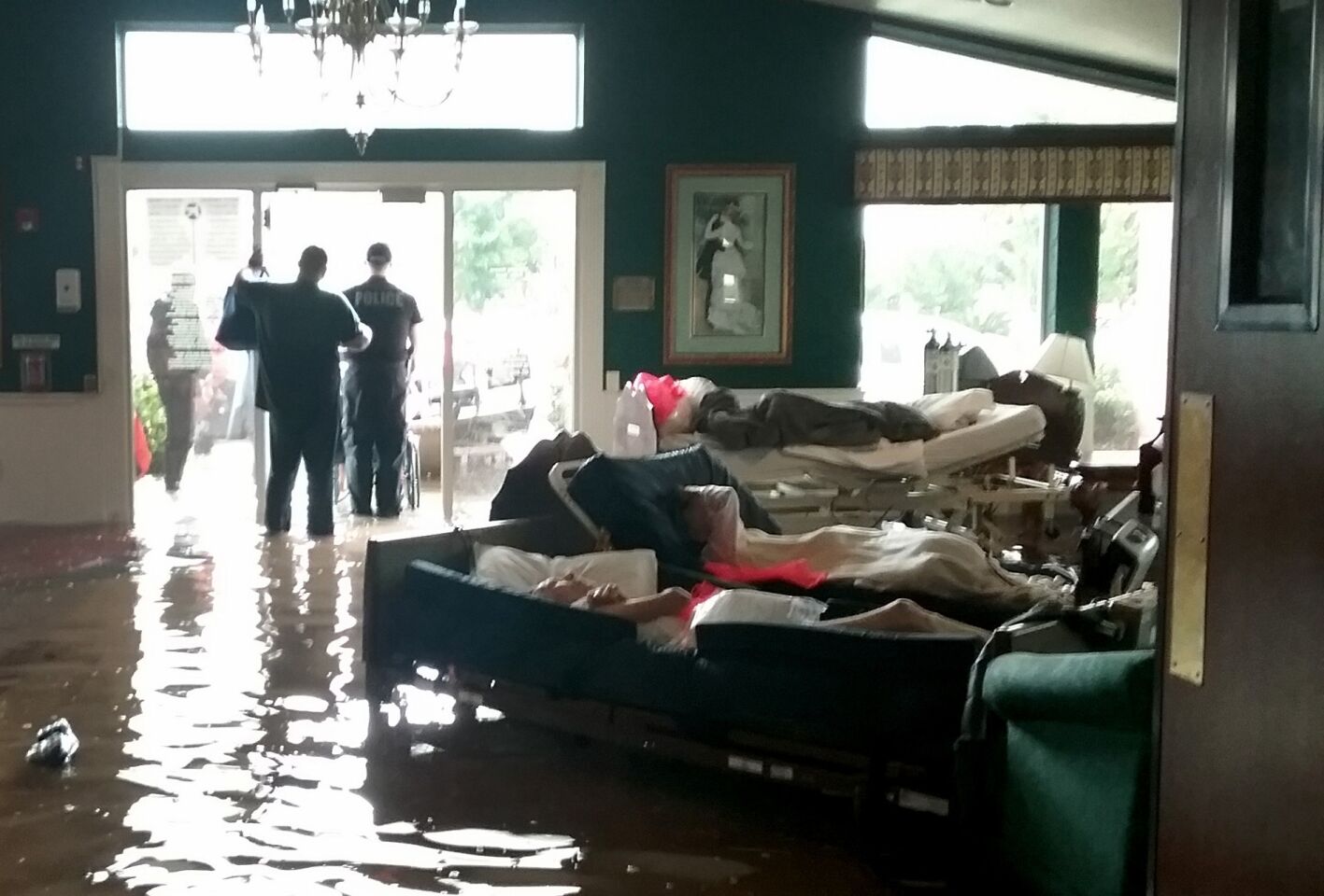 Residents lie on sofas as they wait to be evacuated from the Cypress Glen senior care facility in Port Arthur, Texas, which was inundated with floodwaters from Tropical Storm Harvey on Wednesday.
