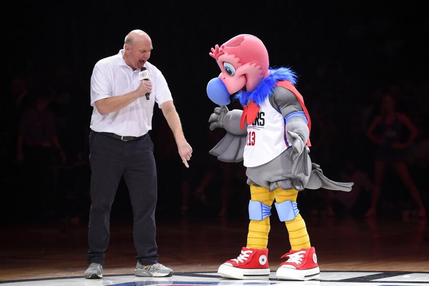 Clippers owner Steve Ballmer introduces the team's new mascot, a California Condor named Chuck, during halftime.