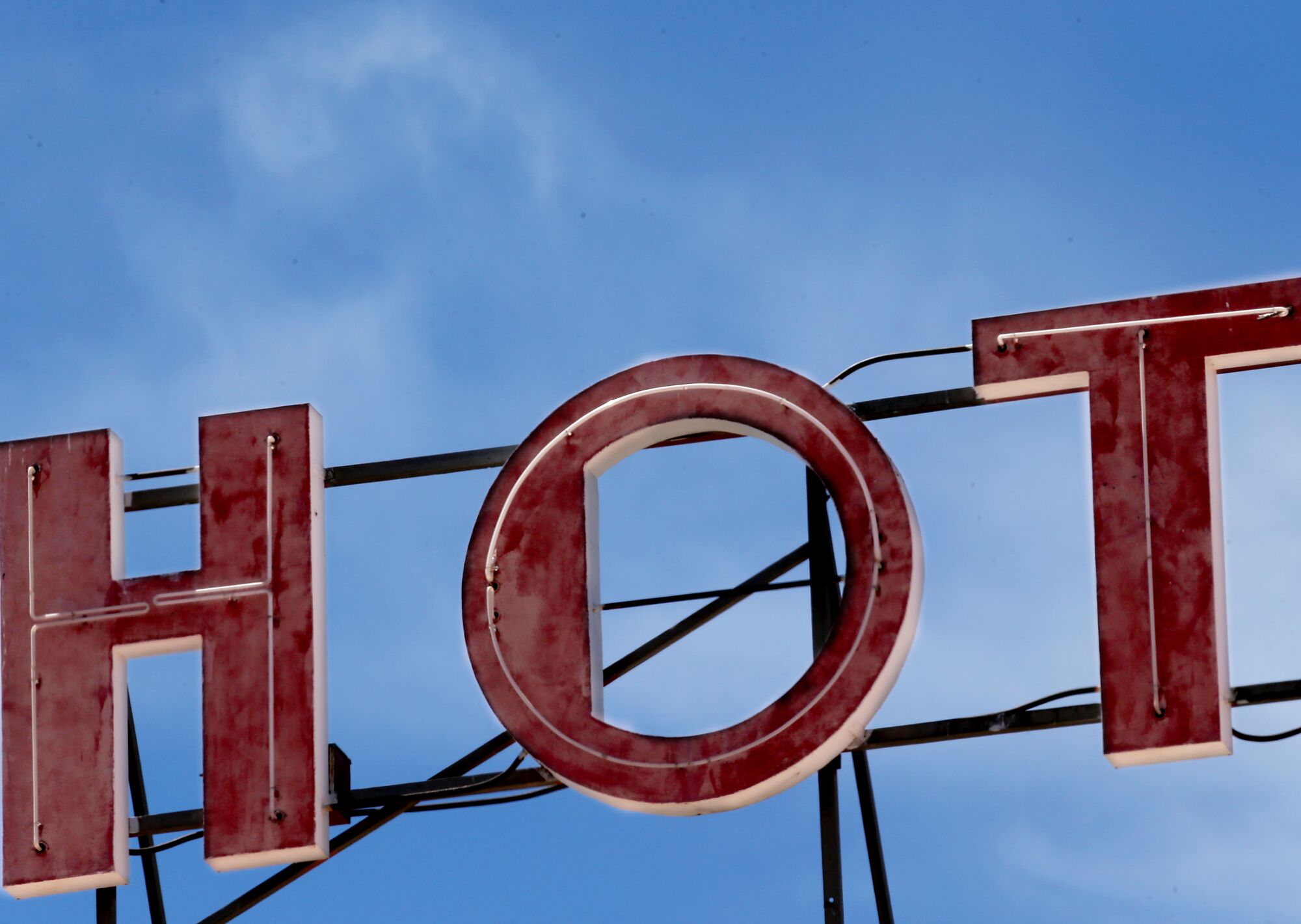Three letters in a hotel sign spell out "HOT."