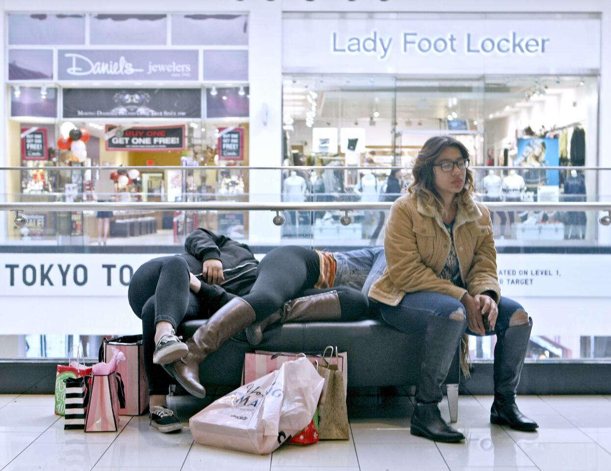 A trio of Black Friday shoppers takes a break at the Glendale Galleria on Friday, Nov. 25, 2016.