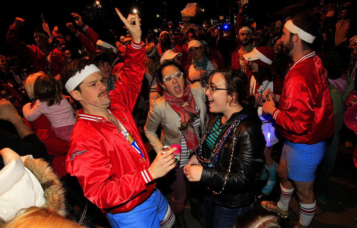 Stomper Eric Charleston dances with revelers in New Orleans. The leader of the 610 Stompers, Brett Patron, says, "I have zero shame."