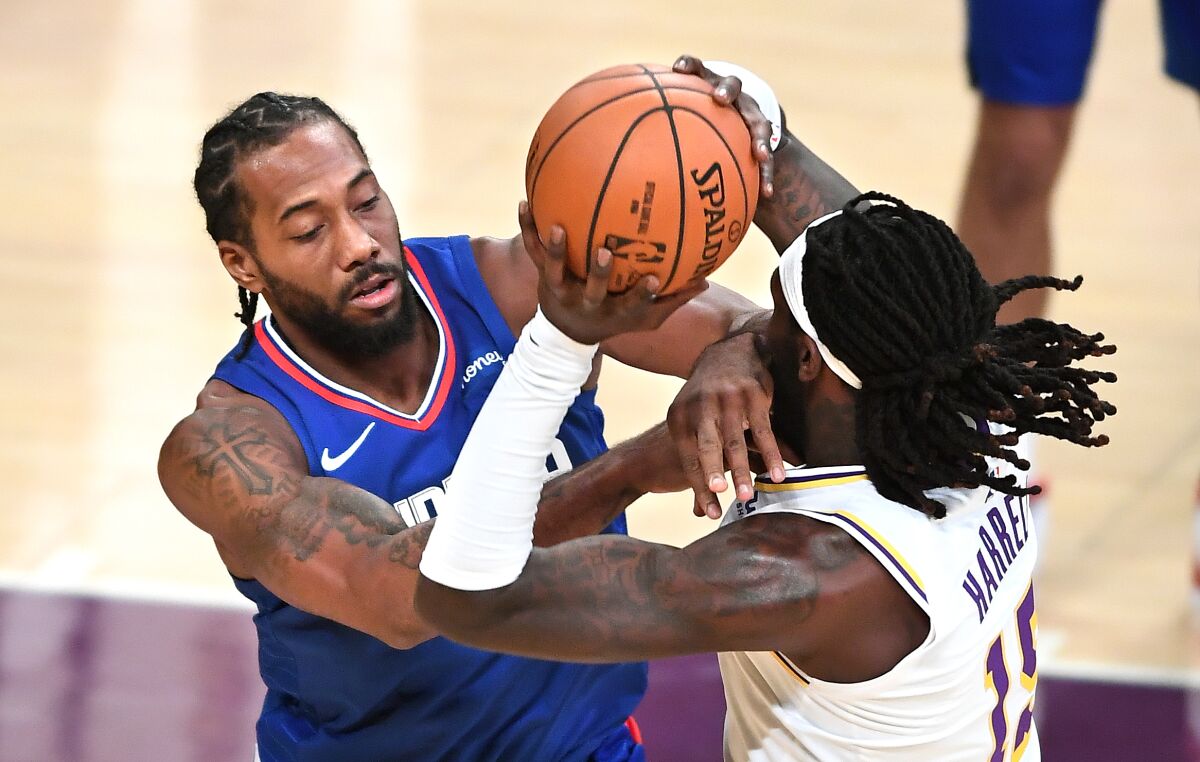 The Clippers' Kawhi Leonard fouls the Lakers' Montrezl Harrell during an exhibition game Dec. 11, 2020. 