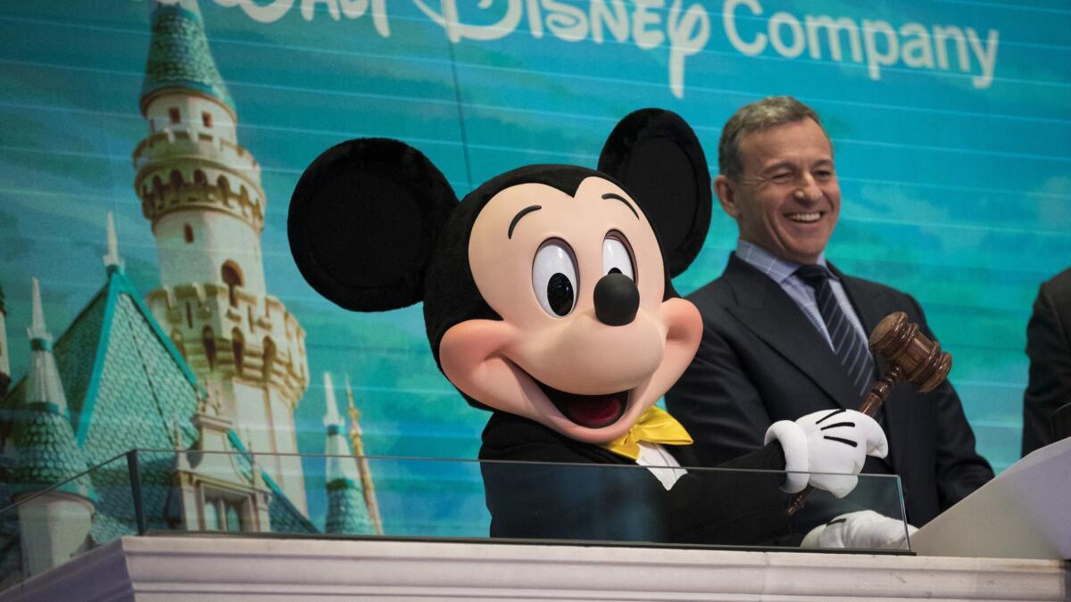 Mickey Mouse and Walt Disney Co. Chief Executive Robert Iger ring the opening bell at the New York Stock Exchange in November.