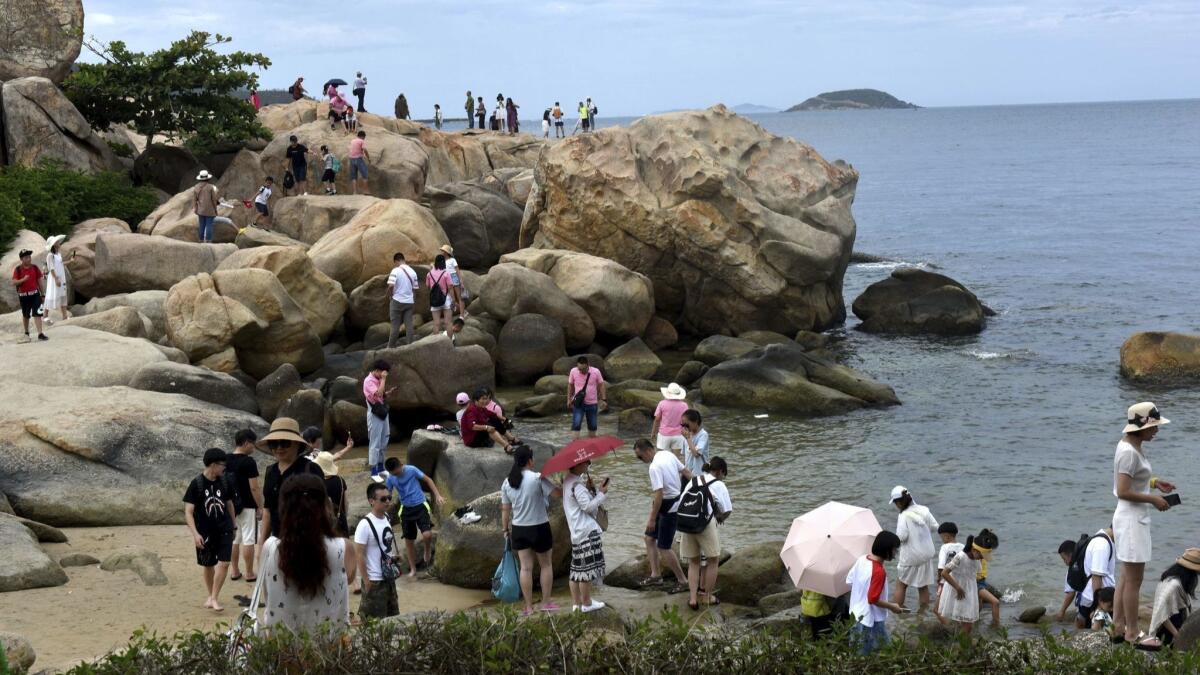 Tourists, most of whom are from China, visit the Truong Son Mountains in Nha Trang, Khanh Hoa province, Vietnam, in August 2018.