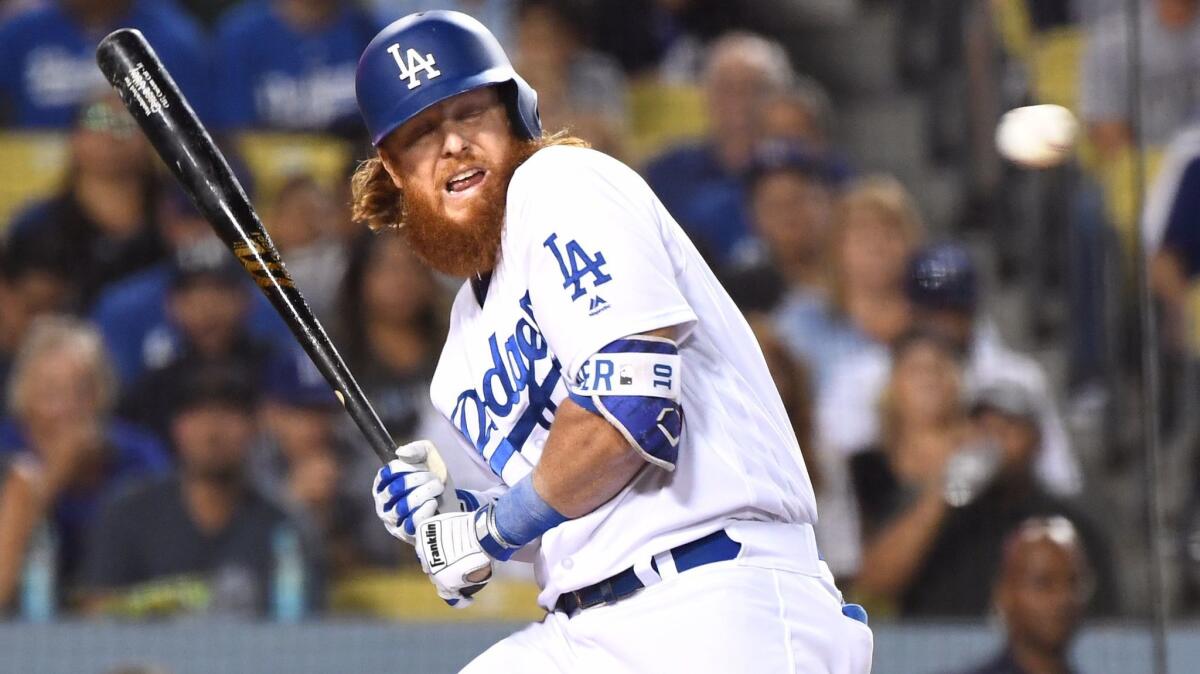 Dodgers third baseman Justin Turner avoids an inside pitch from Rockies pitcher German Marquez during the second inning Friday night.