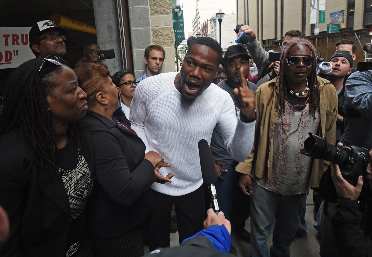 Activist and pastor Westley West, center, on May 23 in Baltimore, after Baltimore City police officer Edward Nero was found not guilty of all charges relating to the death of Freddie Gray last year.