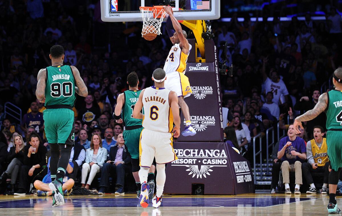 Lakers forward Kobe Bryant steals the ball and dunks it against the Celtics in the second quarter.