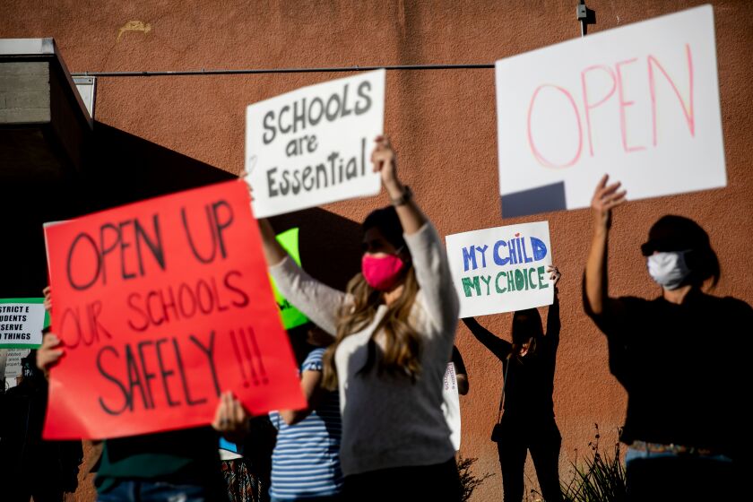 SAN DIEGO, CA - OCTOBER 27: Protesters rally outside the San Diego Unified School District headquarters demanding that schools reopen for in-person learning and that voters oust some of the sitting school board members on Tuesday, Oct. 27, 2020 in San Diego, CA. (Sam Hodgson / The San Diego Union-Tribune)