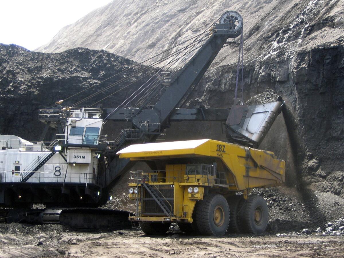 A shovel prepares to dump a load of coal into a 320-ton truck at the Black Thunder mine in Wright, Wyo.