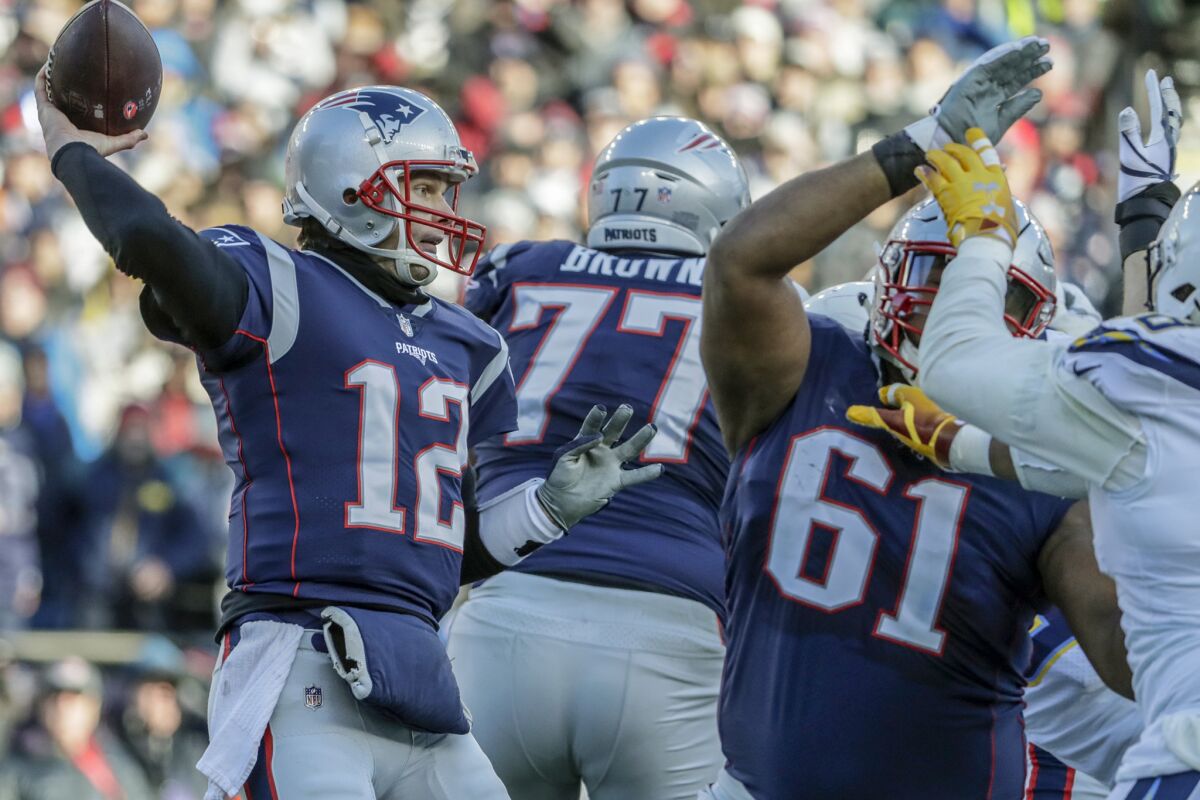 New England Patriots quarterback Tom Brady delivers a pass before rushing Chargers defenders can reach him during first half action in the NFL AFC Divisional Playoff at Gillette Stadium on Sunday.
