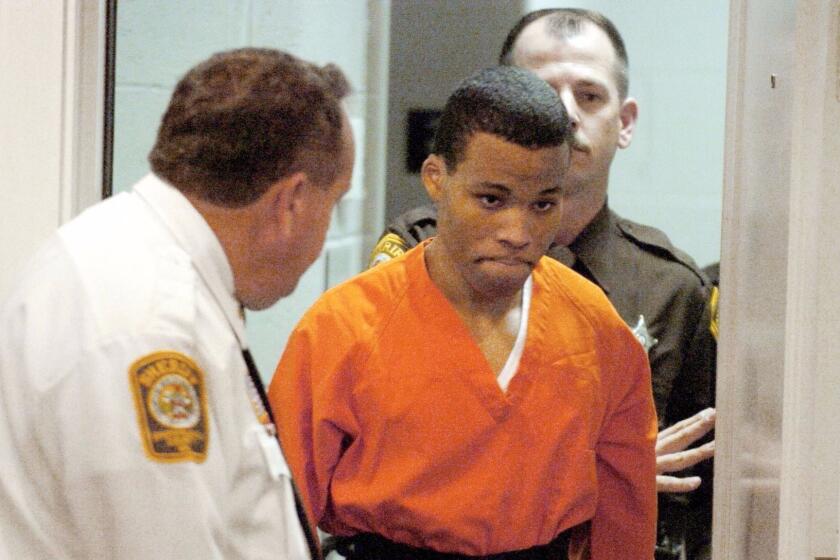 FILE - In this Oct. 26, 2004, file photo, Lee Boyd Malvo enters a courtroom in the Spotsylvania, Va., Circuit Court. A federal judge has tossed out two life sentences for D.C. sniper shooter Lee Boyd Malvo and ordered Virginia courts to hold new sentencing hearings. In a ruling issued Friday, U.S. District Judge Raymond Jackson in Norfolk said Malvo is entitled to new sentencing hearings after the U.S. Supreme Court ruled that mandatory life sentences for juveniles are unconstitutional. (Mike Morones/The Free Lance-Star via AP)