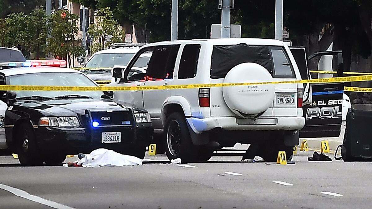 A man armed with a hatchet was shot and killed by officers after a short pursuit ended on Manchester Avenue, west of Sepulveda Boulevard in Westchester on Wednesday, authorities said.