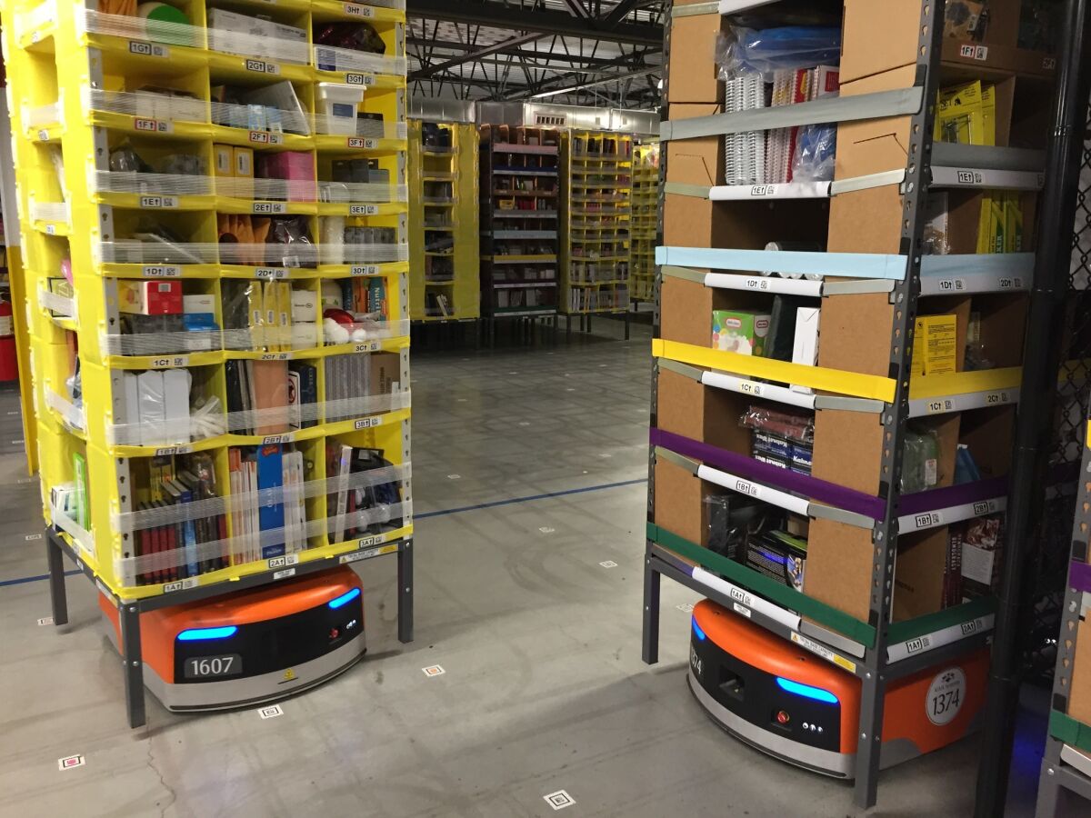 Amazon's orange Kiva robots lift stacks of merchandise and move them to employee stations, eliminating the need for workers to walk around the warehouse searching for items.
