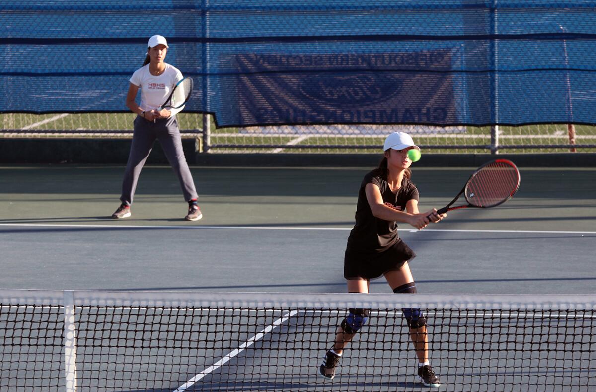 Huntington Beach's doubles team of Le-Nhi Huynh, left, and Ella Weisman competes during Wednesday's match at San Marino.