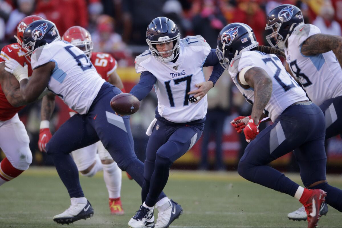 FILE - In this Jan. 19, 2020, file photo, Tennessee Titans quarterback Ryan Tannehill (17) looks to hand the ball off during the first half of the AFC championship NFL football game against the Kansas City Chiefs in Kansas City, Mo. The Tennessee Titans are confident enough Ryan Tannehill can repeat the best season of his career, or close enough, that they gave him a four-year, $118 million contract. (AP Photo/Charlie Riedel, File)