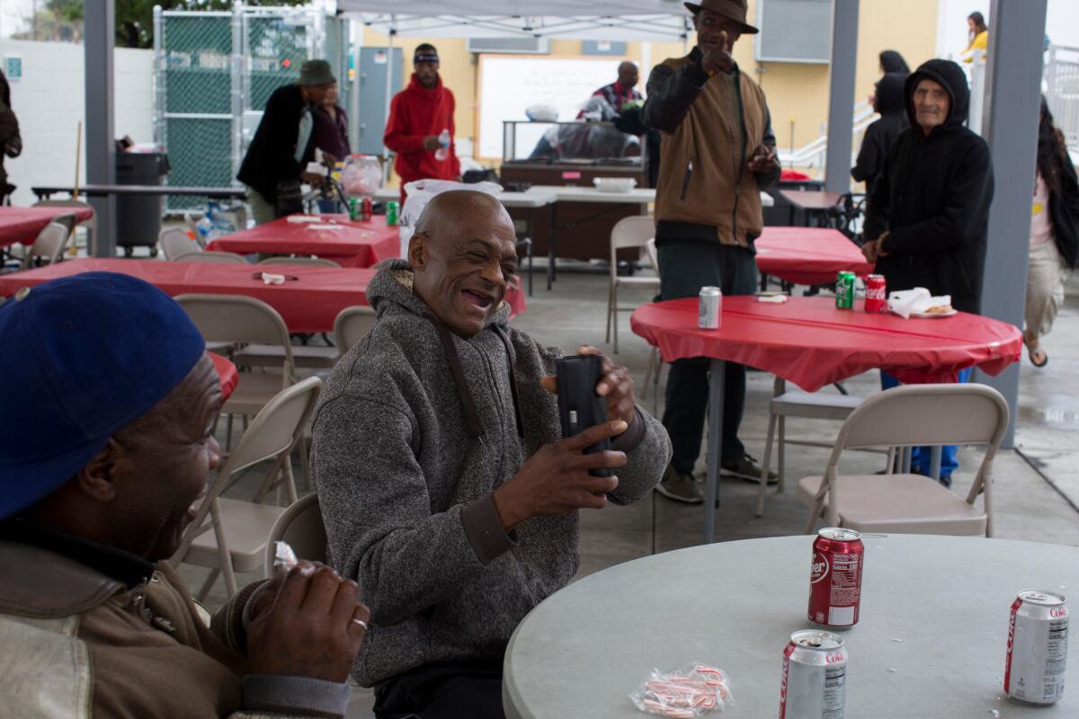 Residents joke around during a holiday lunch held at a shelter in Watts.