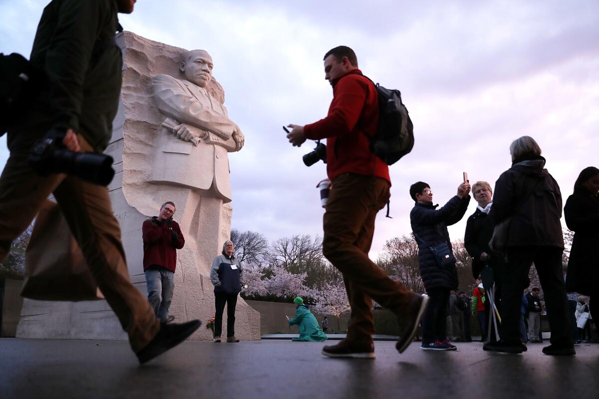 Marchers gather at the Martin Luther King Jr. Memorial in Washington, D.C., to walk to a prayer service on the National Mall to mark the 50th anniversary of King's assassination.