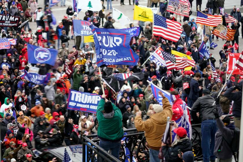 FILE - Violent protesters gather outside the U.S. Capitol, Jan 6, 2021. (AP Photo/Andrew Harnik, File)