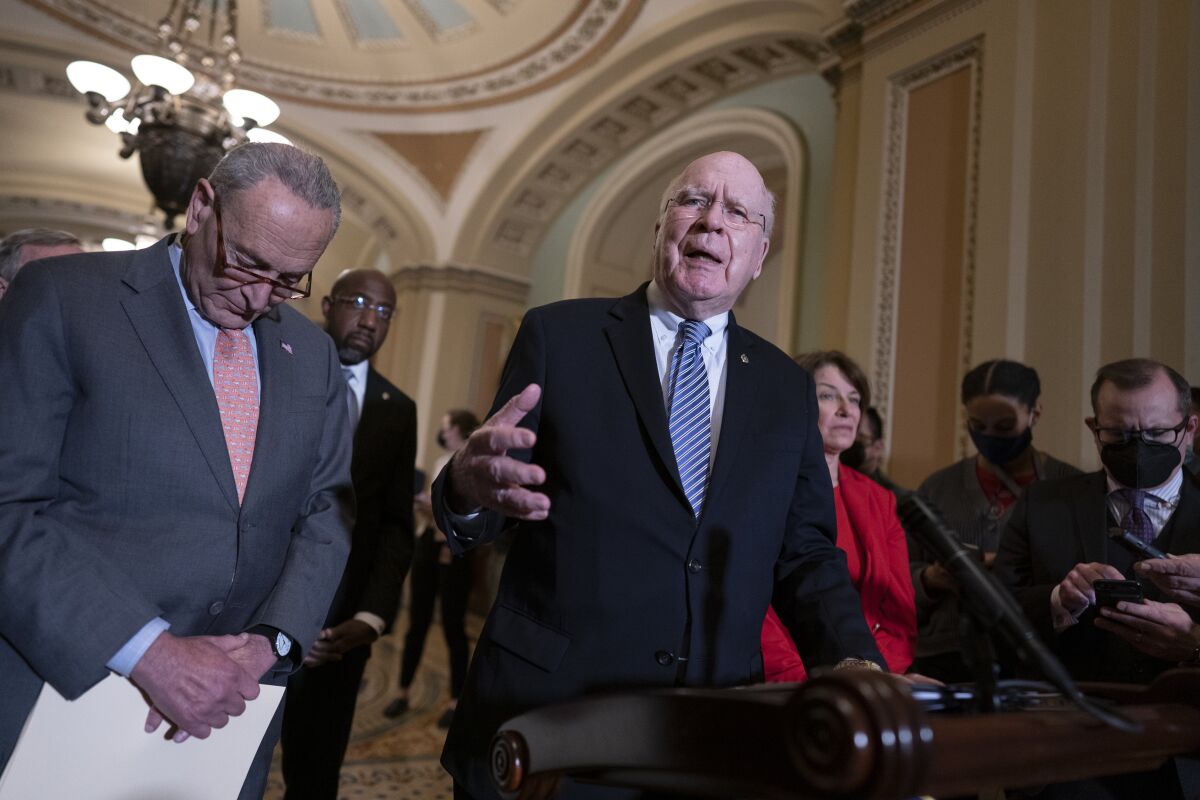 FILE - From left, Senate Majority Leader Chuck Schumer, D-N.Y., Sen. Raphael Warnock, D-Ga., Sen. Patrick Leahy, D-Vt., chair of the Senate Appropriations Committee, and Sen. Amy Klobuchar, D-Minn., chair of the Senate Rules Committee, talk about the need for the John Lewis Voting Rights Advancement Act, as they speak to reporters following a Democratic policy meeting at the Capitol in Washington, Nov. 2, 2021. Democrats are mounting an impassioned push to overhaul Senate rules that stand in the way of their sweeping elections legislation, arguing dark forces unleashed by Donald Trump's “big lie” about the 2020 presidential contest pose such a grave threat to democracy that they demand a forceful response. (AP Photo/J. Scott Applewhite)