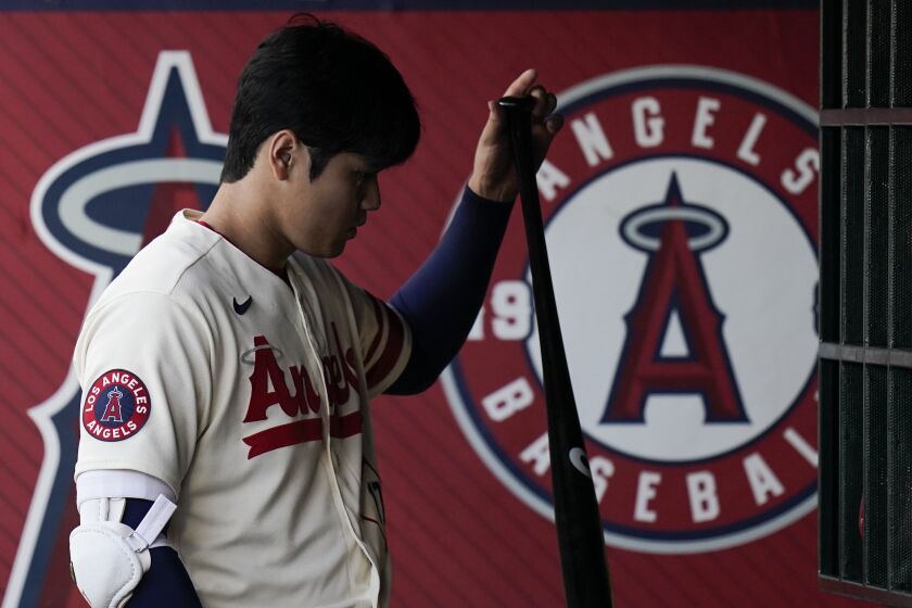 Los Angeles Angels' Shohei Ohtani grabs his bat during the first inning of a baseball game,