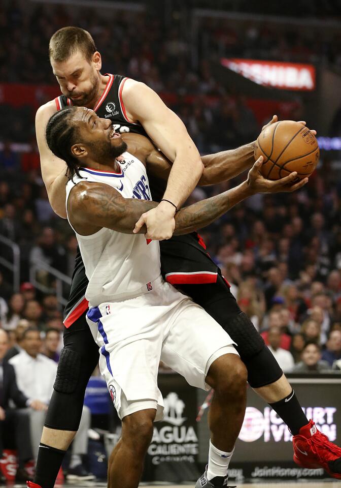 Clippers forward Kawhi Leonard is fouled by Raptors center Marc Gasol during the second quarter of a game Nov. 11 at Staples Center.