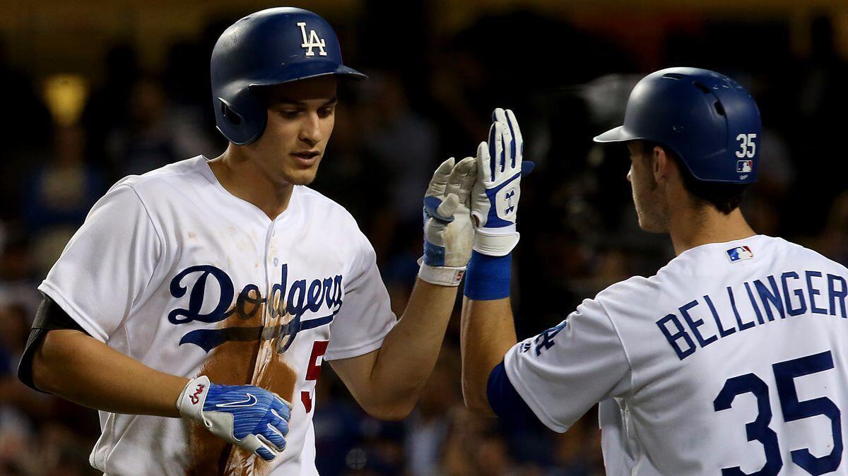 Dodgers shortstop Corey Seager is congratulated by teammate Cody Bellinger after hitting a three-run homer against the Padres in the seventh inning Tuesday night at Dodger Stadium.