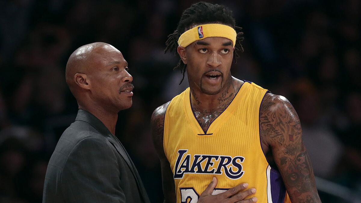 Lakers Coach Byron Scott, left, speaks with forward Jordan Hill during a preseason game against the Golden State Warriors on Oct. 9, 2014.
