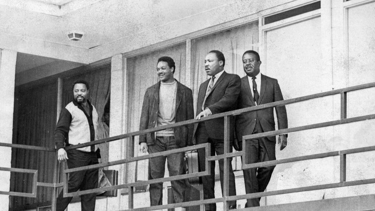 Martin Luther King Jr. on the balcony of a Memphis motel at approximately the spot where he was shot by an assassin. This picture was taken Wednesday, the day before the shooting, shortly after King arrived in Memphis.