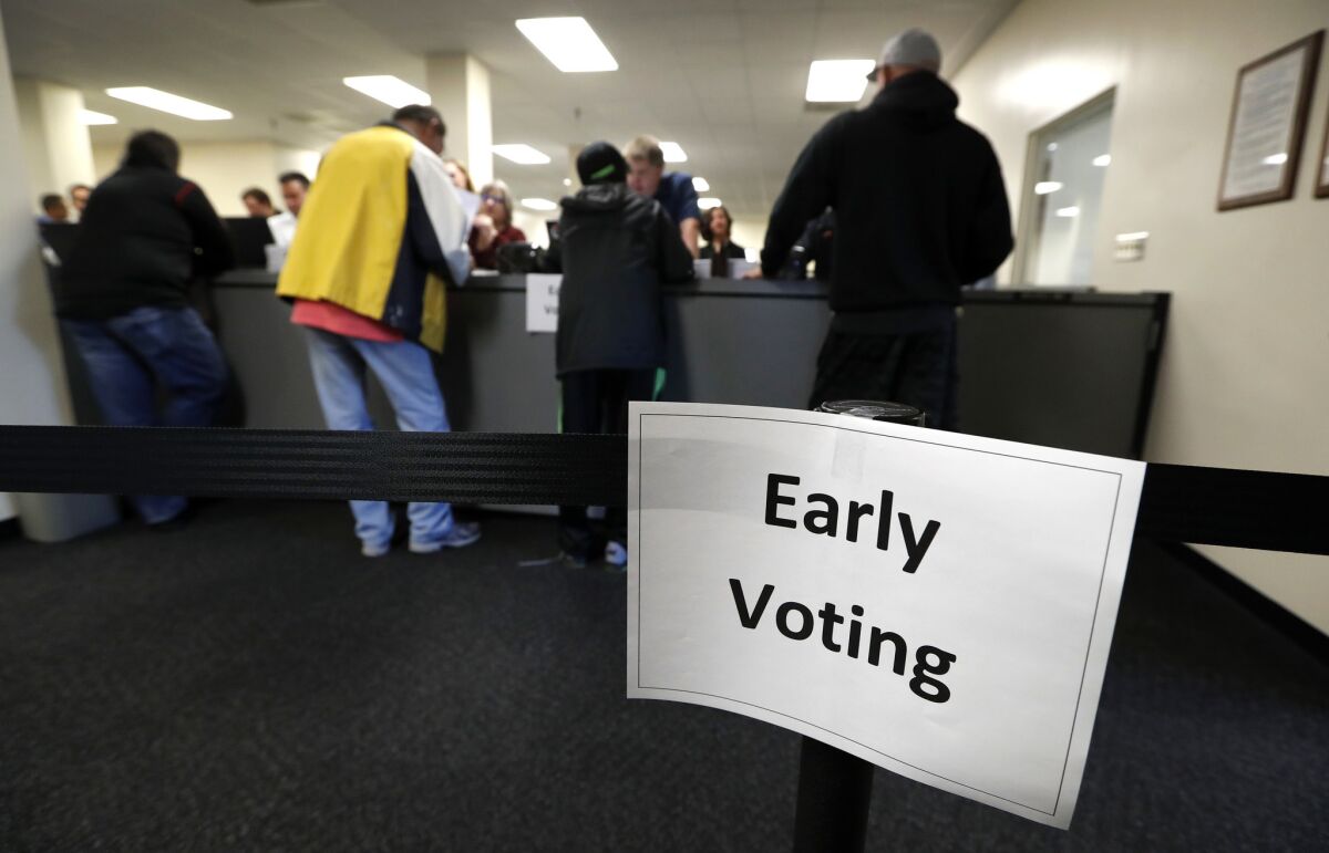 Residents receive their ballots at the Polk County Election Office on the first day of early voting in Des Moines, Iowa.
