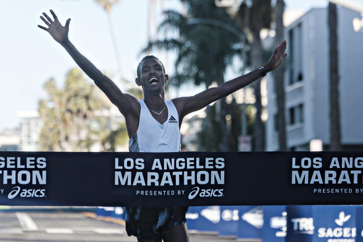 Bayelign Teshager, 20, of Ethiopia completes the 2020 Los Angeles Marathon on Sunday in Santa Monica.