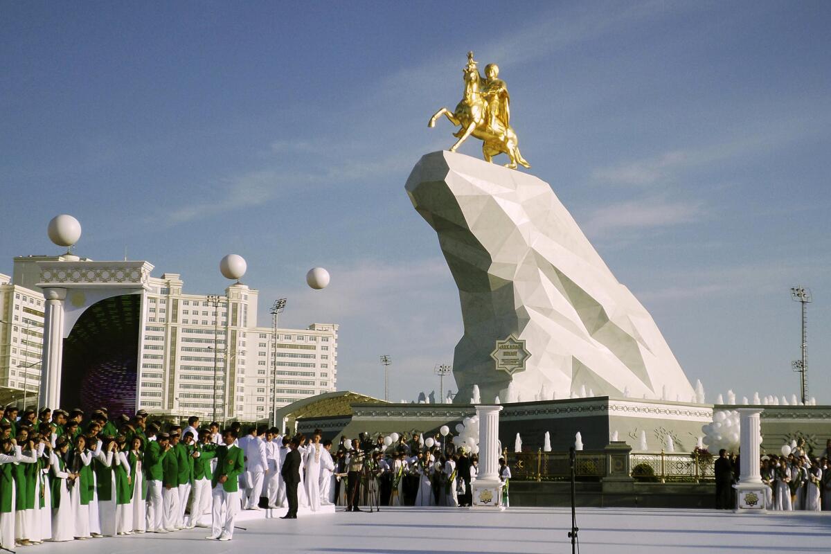 In Turkmenistan, President Gurbanguly Berdymukhamedov has built a very Las Vegas statue to himself in Ashgabat. Crowds gather for the unveiling on Monday.