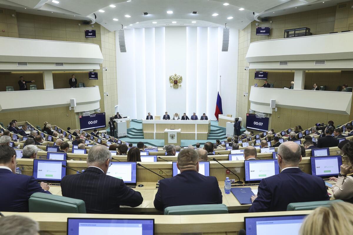 Russian lawmakers attend a session in Moscow