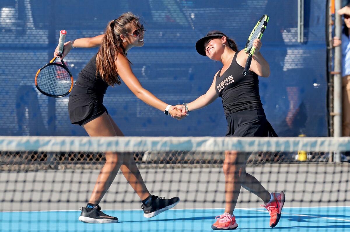 Huntington Beach's Cindy Huynh, left, and Sophie Jin-Ngo celebrate winning a point at Villa Park on Sept. 2.