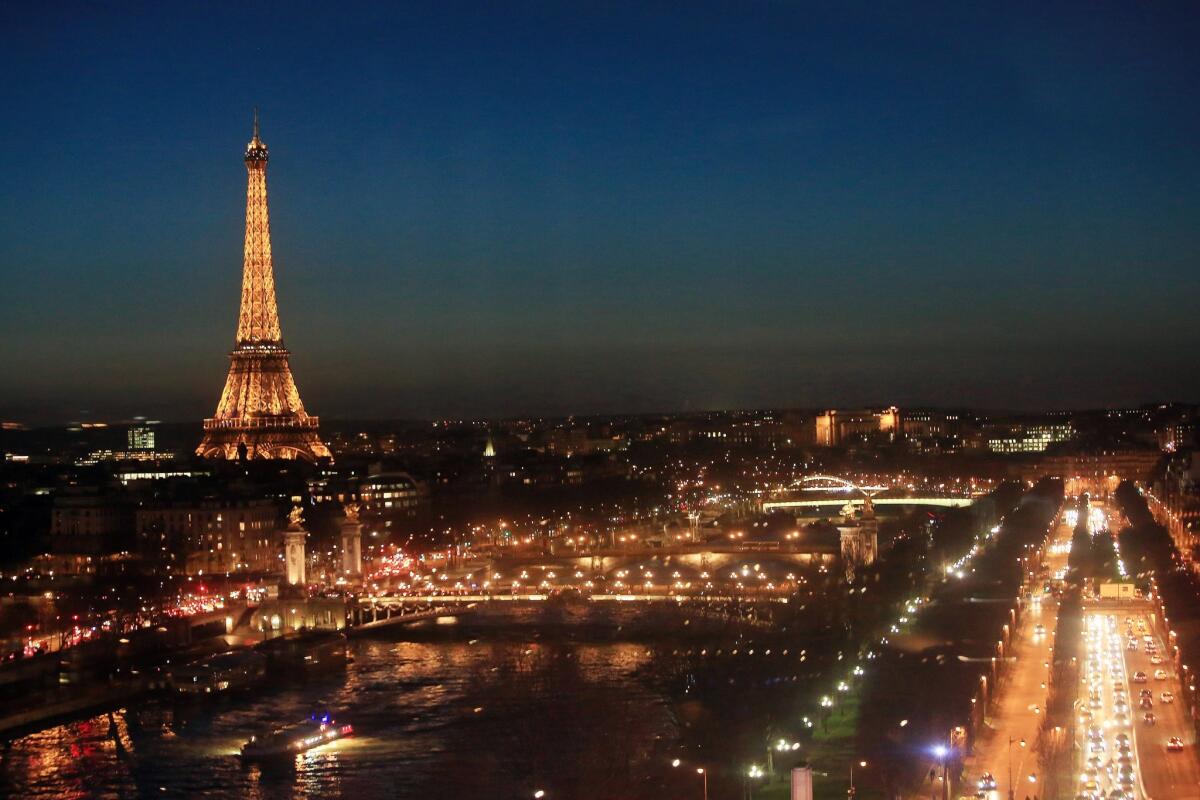 The Eiffel Tower glows at night in the French capital.