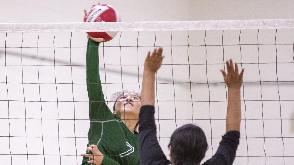 Ashley Nguyen, shown hitting against Artesia on Aug. 18, helped the Costa Mesa High girls' volleyball team reach the quarterfinals of its second straight tournament.