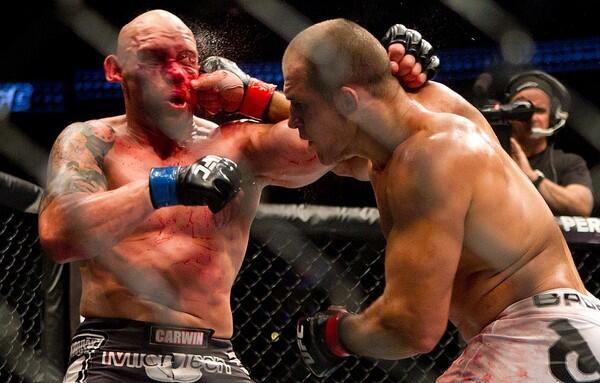 Junior Dos Santos pummels Shane Carwin with an overhand right during their heavyweight bout at UFC 131 on Saturday night in Vancouver, Canada.