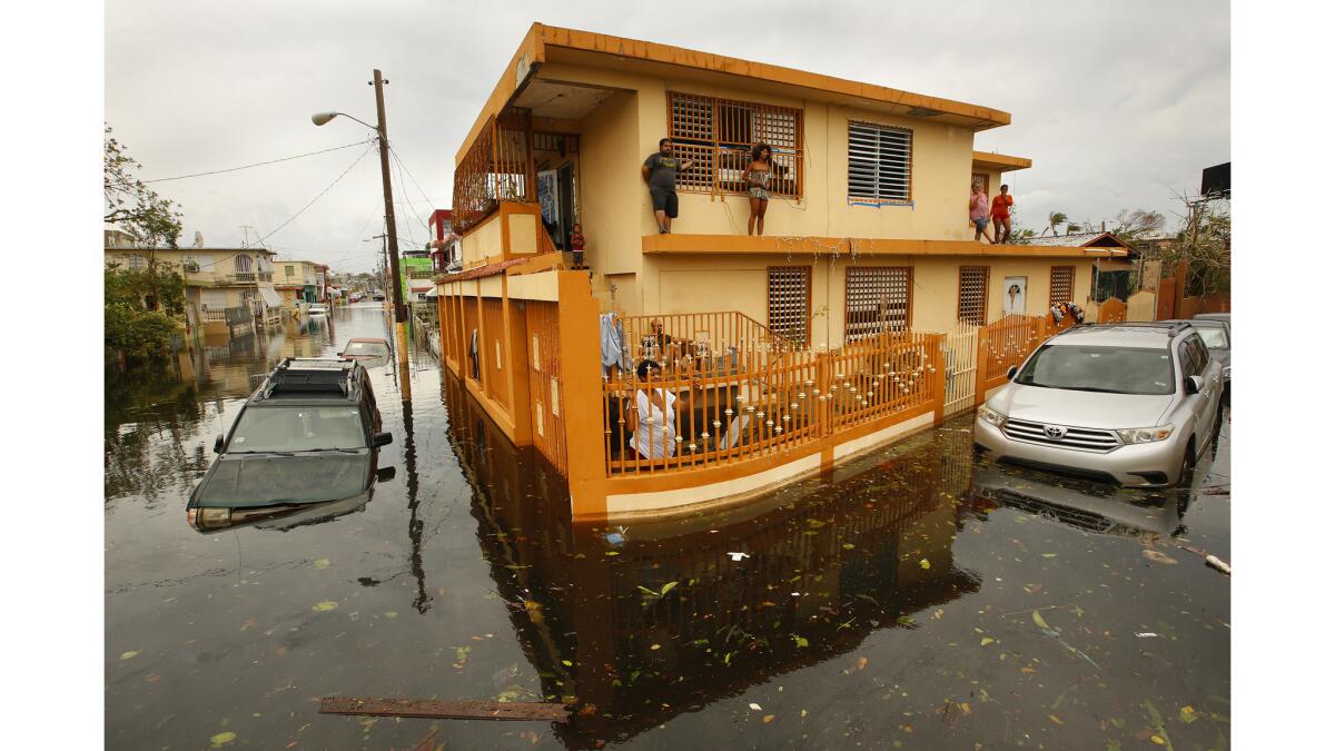 The day after Hurricane Maria made a direct hit on Puerto Rico, residents of Isla Palmeras neighborhood in San Juan, are surrounded by water.