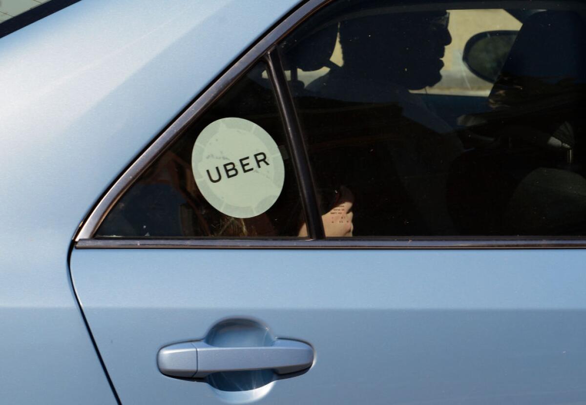 An Uber driver and car with a passenger 