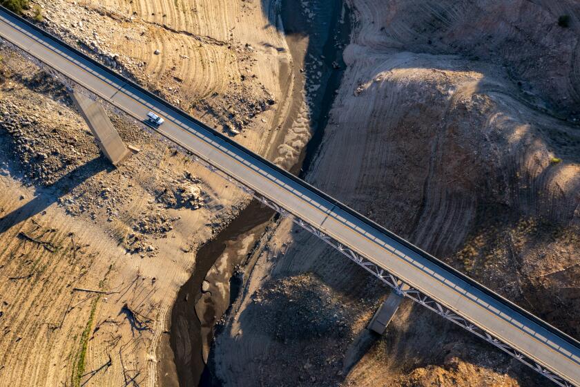 OROVILLE, CA - JUNE 30: A truck crosses the Enterprise Bridge at Lake Oroville, which stands at 33 percent full and 40 percent of historical average when this photograph was taken on Wednesday, June 30, 2021 in Oroville, CA. (Brian van der Brug / Los Angeles Times)