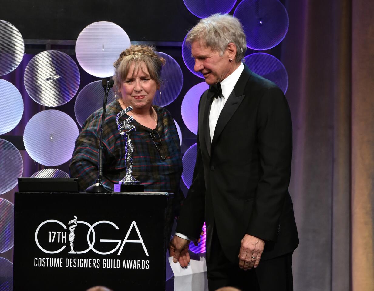 Costume designer Aggie Guerard Rodgers receives the career achievement award from longtime friend Harrison Ford.
