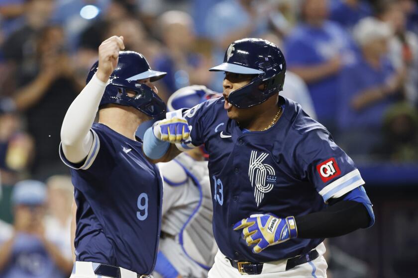 Kansas City Royals' Salvador Perez (13) celebrates with Vinnie Pasquantino (9) after hitting a three-run home run during the seventh inning of a baseball game against the Texas Rangers in Kansas City, Mo., Friday, May 3, 2024. (AP Photo/Colin E. Braley)