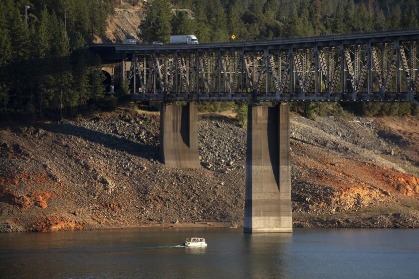 SHASTA LAKE, CA - July 15: Traffic on Interstate 5 passes over Shasta Lake on the Pit River Bridge. Years-long drought has dropped the water level exposing the "bathtub ring" at Shasta Lake in California. Photographed on Friday, July 15, 2022 in Shasta Lake, Shasta County CA. (Myung J. Chun / Los Angeles Times)