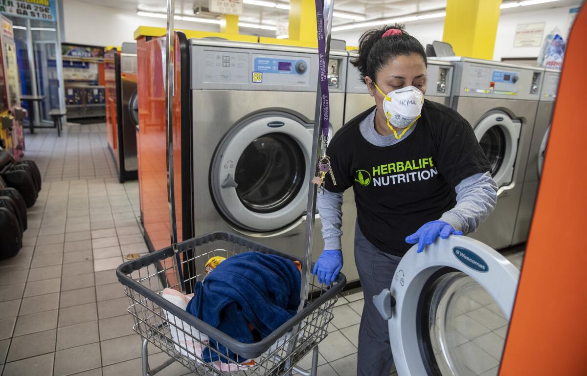 Irma Juárez does her laundry at a self-service laundry in her Pico-Union neighborhood.