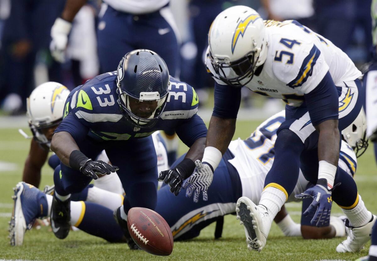 Seahawks running back Christine Michael and Chargers linebacker Melvin Ingram go after a ball that was fumbled by Michael on Friday night.