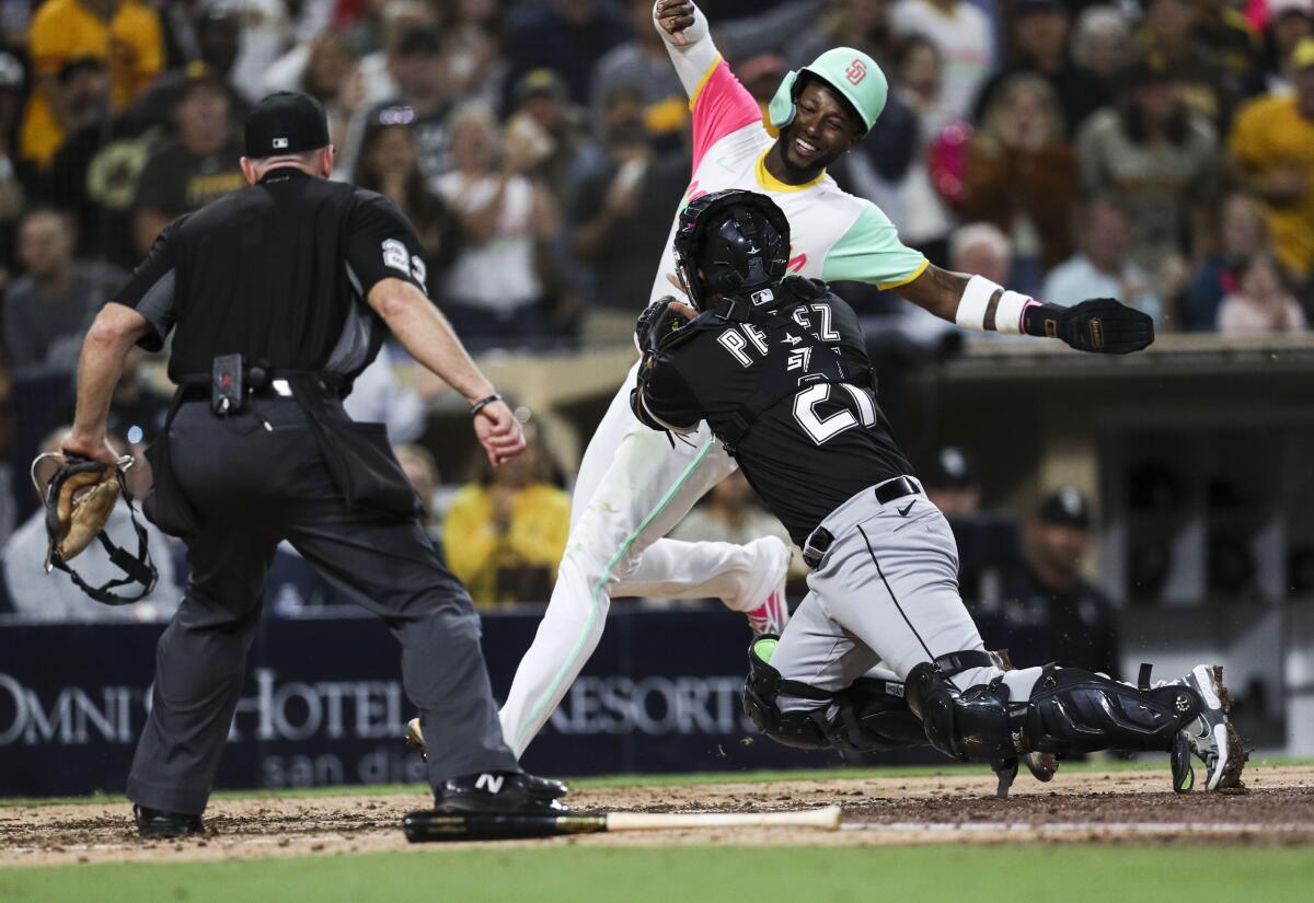 The Padres' Jurickson Profar is tagged out by White Sox catcher Carlos Perez.