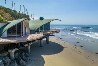 The iconic home hovers above the ocean in Malibu, curling to resemble the rolling waves beneath it.